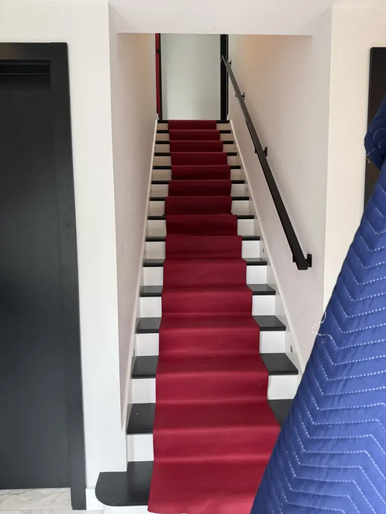 Protective runners covering the stairs and the area at the foot of a staircase.